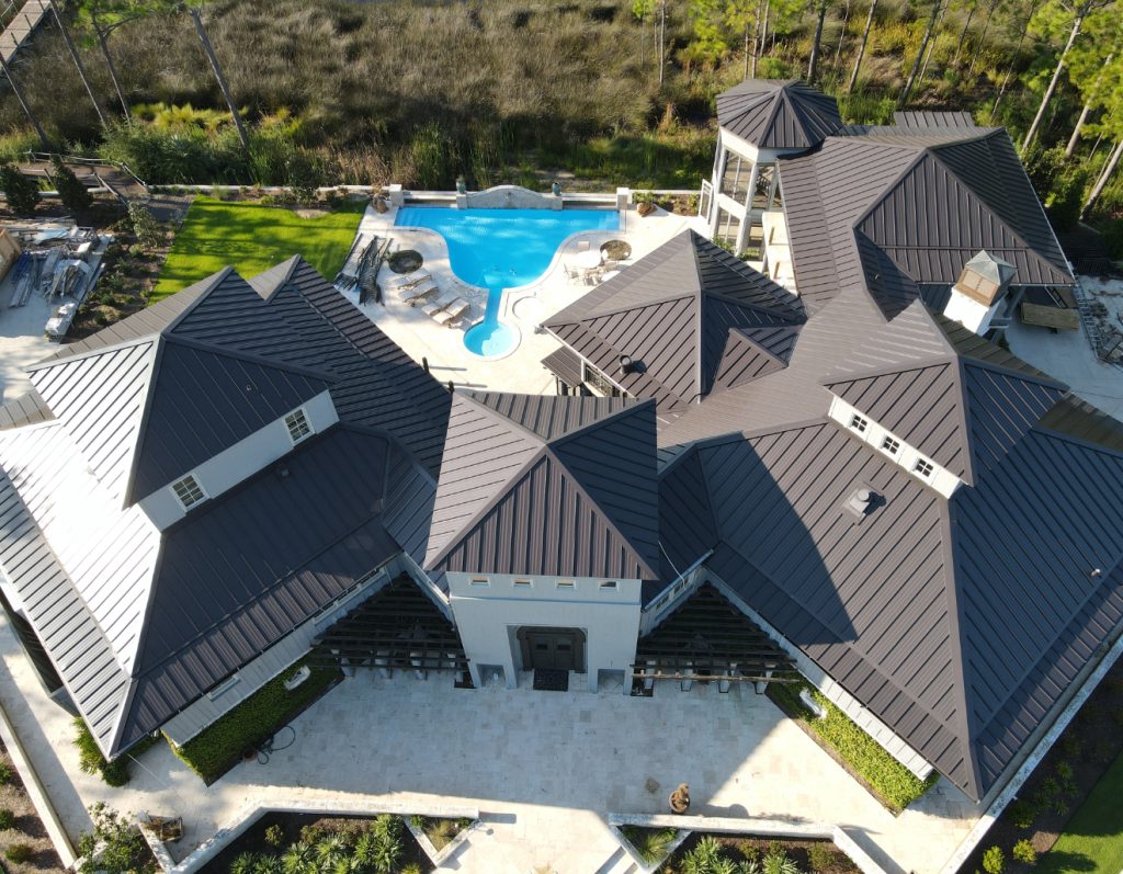 Aerial view of a standing seam metal roof installed by Talton Roofing on a home with a pool