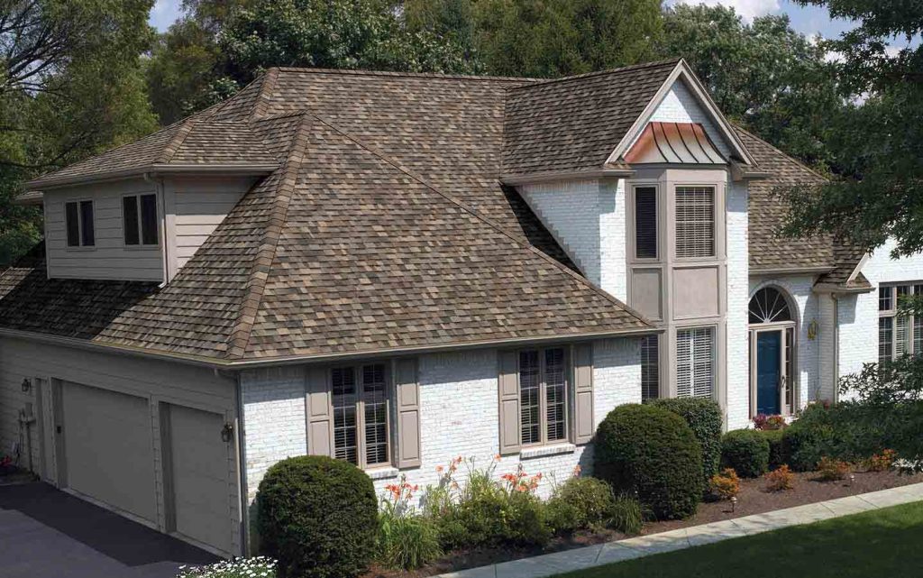 Large two-story home with a new brown shingle roof