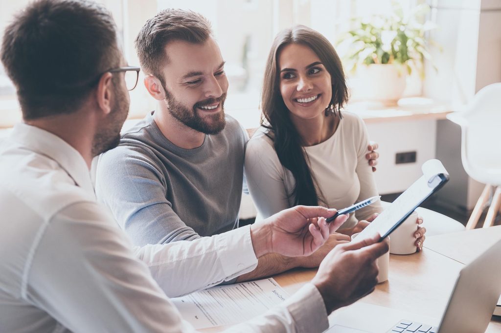 Homeowners reviewing roof financing options with an advisor