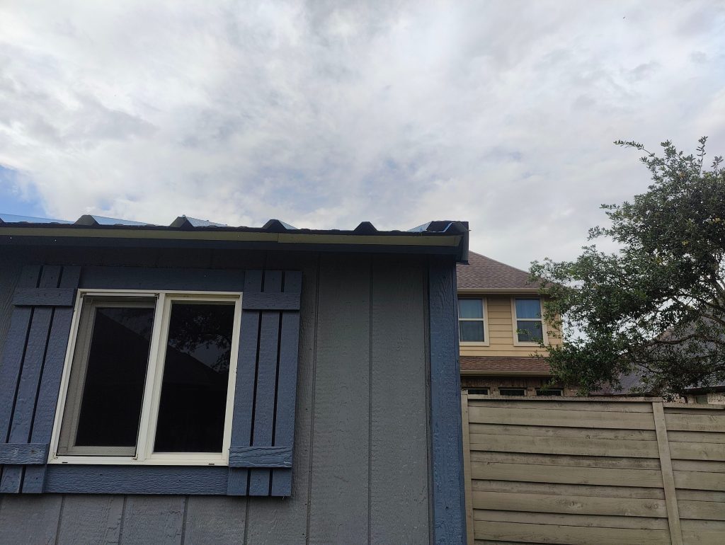 Home exterior with board and batten siding and a new window