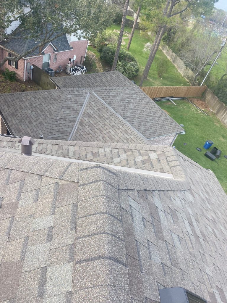 Newly installed architectural shingle roof on a two-story home with a backyard view