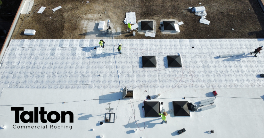 Talton Commercial Roofing crew working on a flat roof with skylights