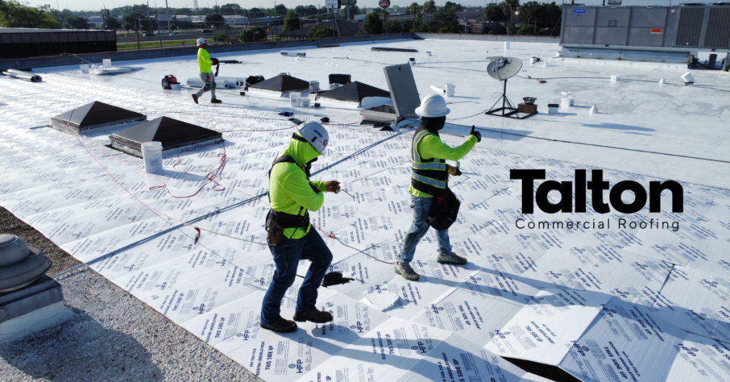 Talton Commercial Roofing crew installing a flat roof membrane